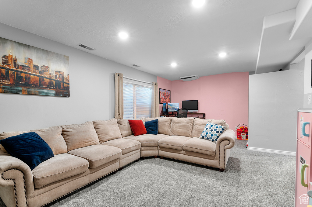 Carpeted living room with recessed lighting