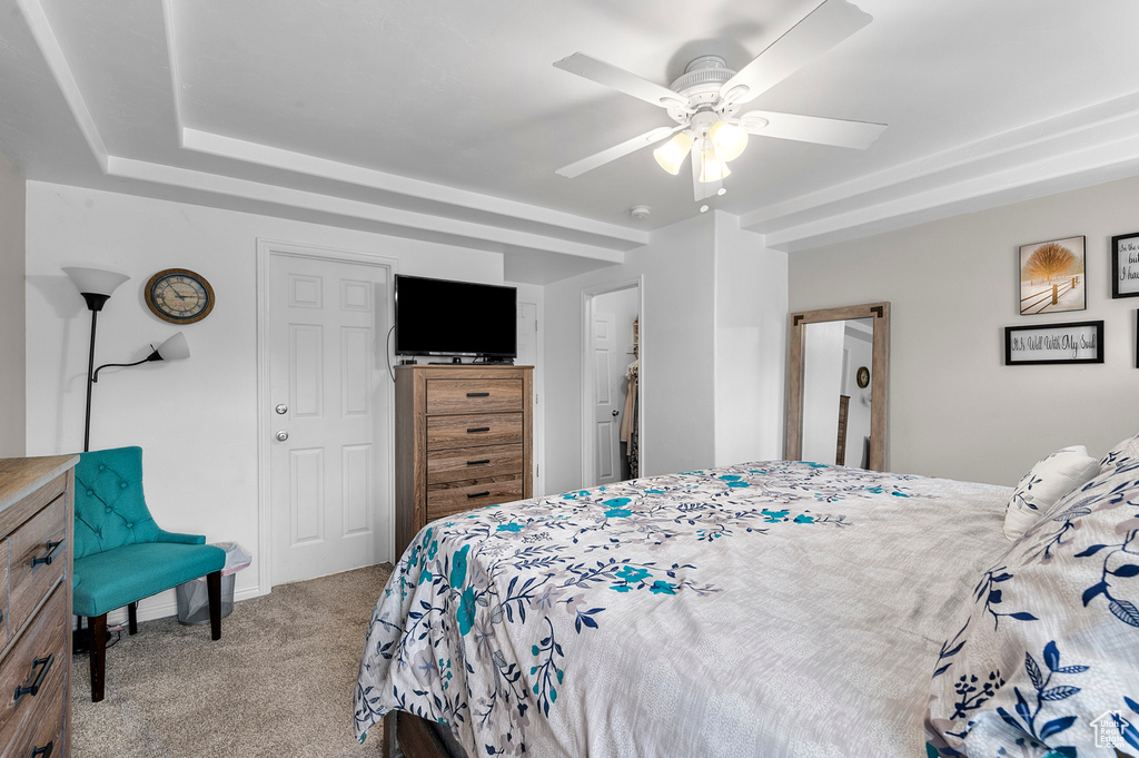Carpeted bedroom featuring a ceiling fan