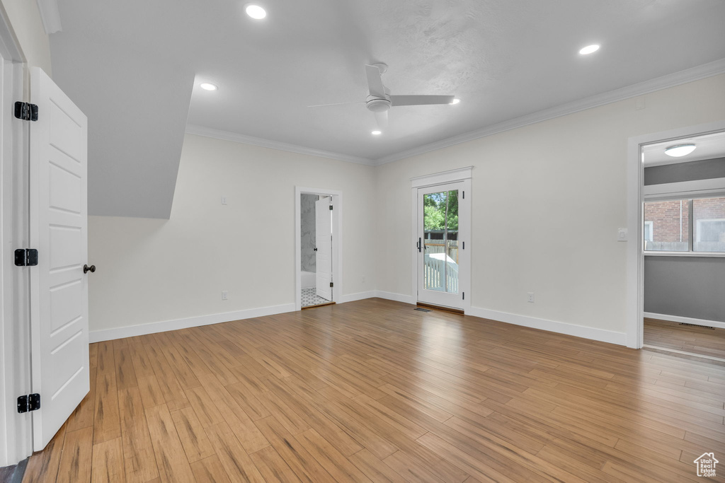 Spare room with a ceiling fan, crown molding, light wood-style flooring, and recessed lighting