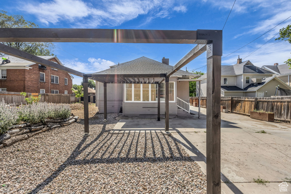 Fenced backyard with a pergola and a patio