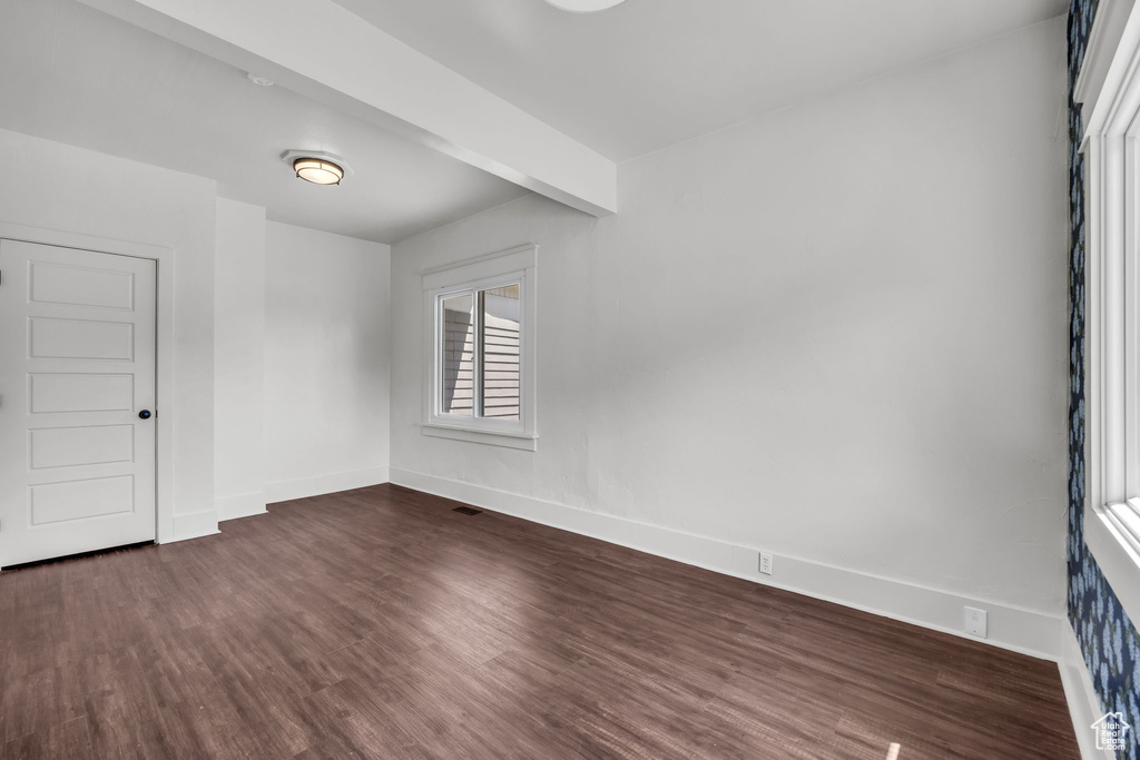 Unfurnished room with dark wood-style floors