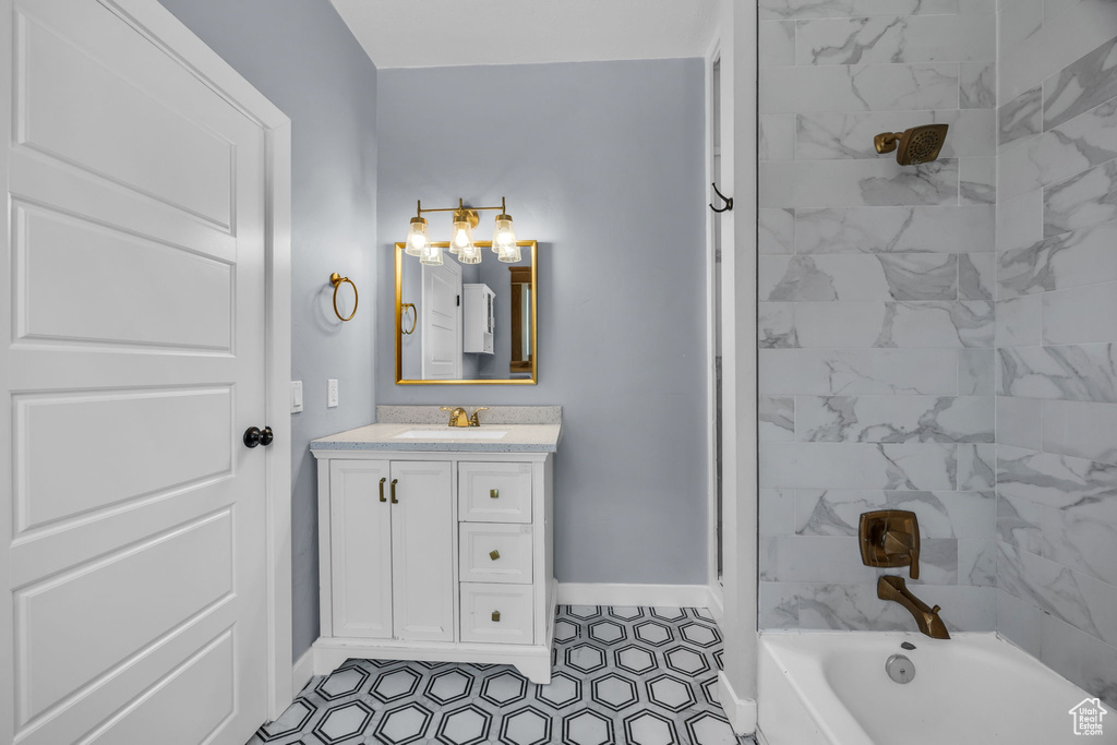 Bathroom with a tub to relax in, vanity, and a shower