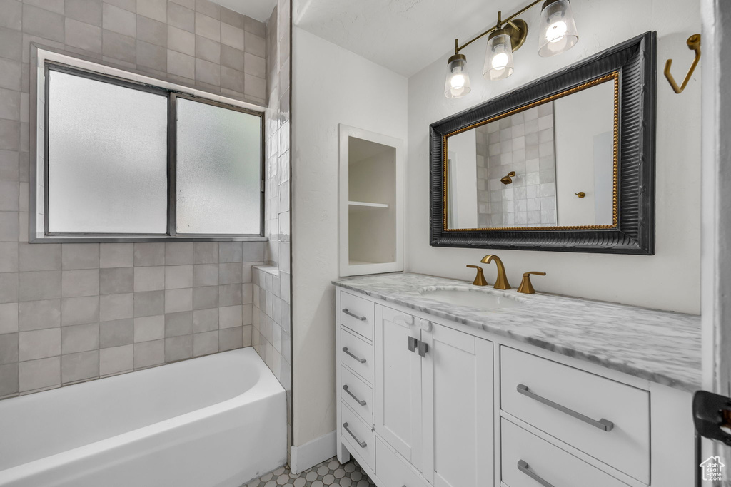 Bathroom with vanity, a tub to relax in, and a shower