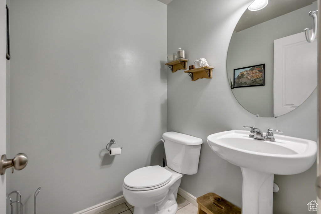 Bathroom with toilet and tile patterned floors
