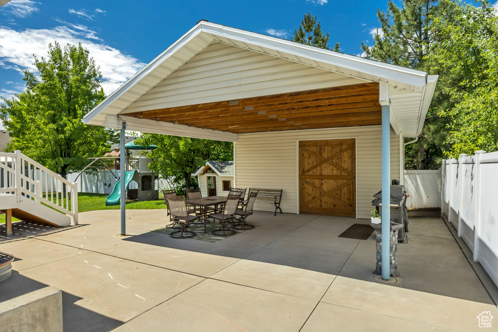 View of patio / terrace with a playground, an outbuilding, and outdoor dining space