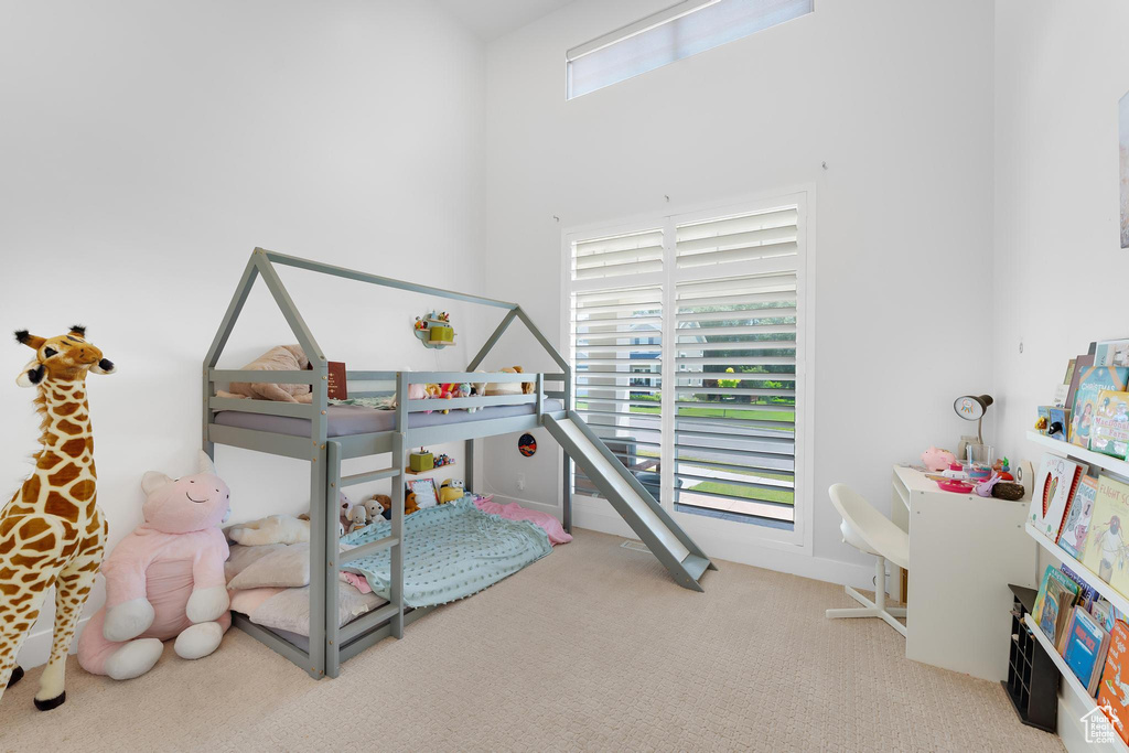 Bedroom featuring carpet floors and multiple windows