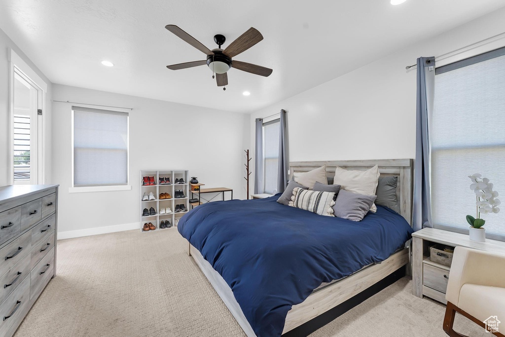 Carpeted bedroom with recessed lighting and a ceiling fan