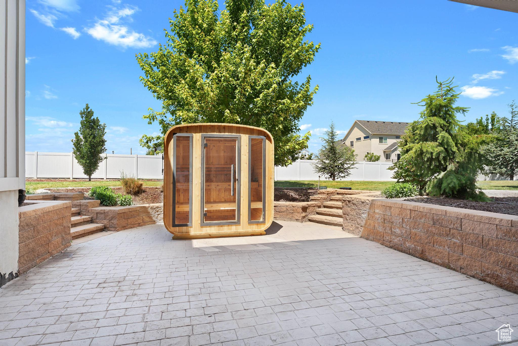 Fenced backyard with a patio and a storage shed