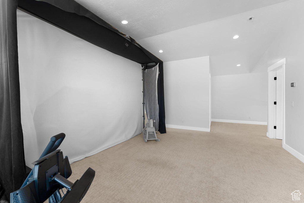 Carpeted home theater room with recessed lighting