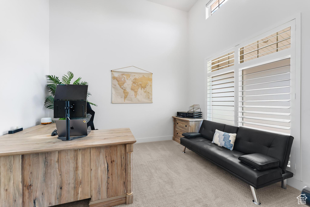 Carpeted office space with baseboards