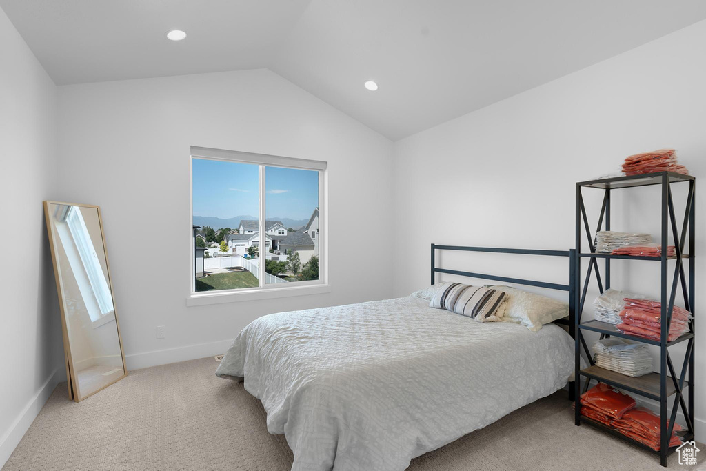 Carpeted bedroom featuring lofted ceiling and recessed lighting
