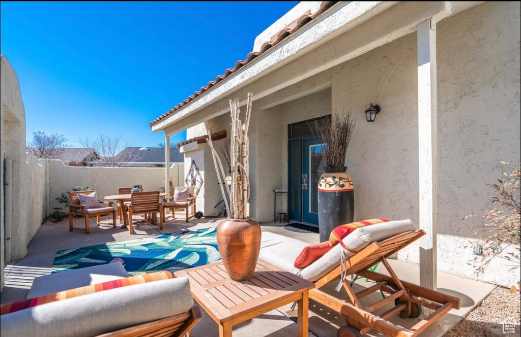 Fenced backyard featuring outdoor dining area and a patio