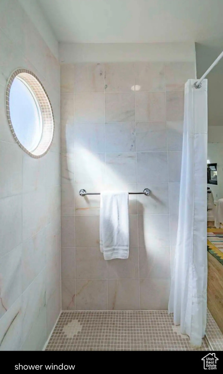 Full bath with a tile shower