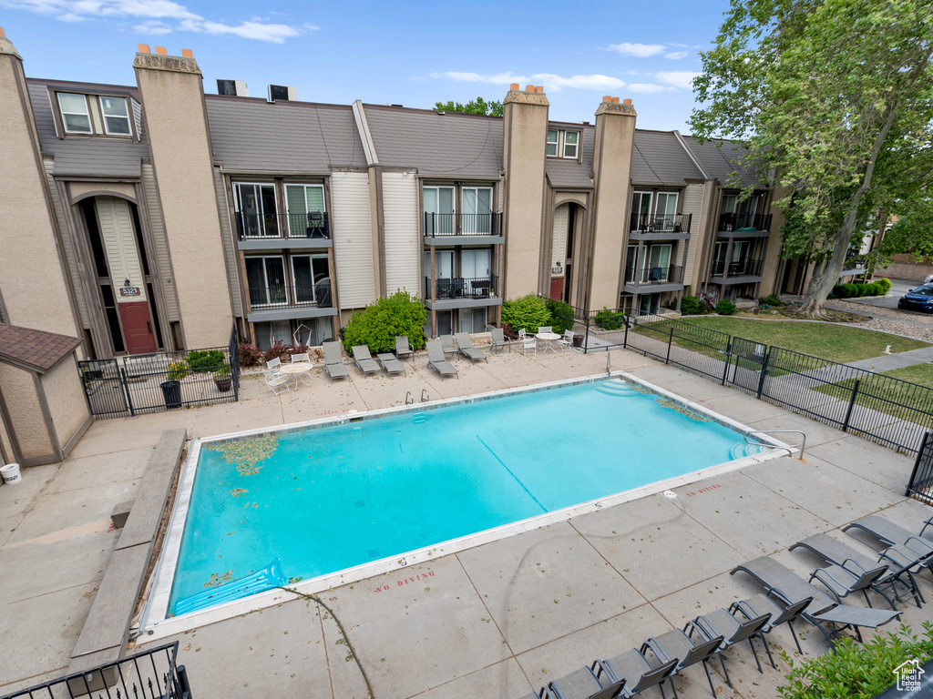 Community pool with a patio