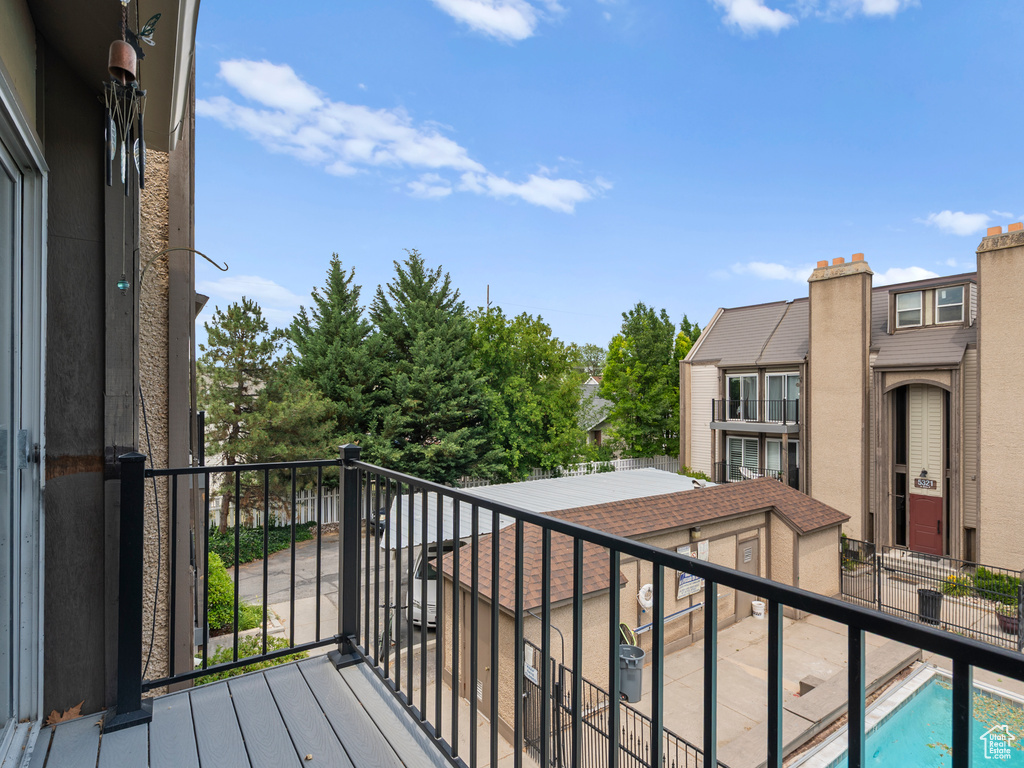 Balcony featuring view of pool area
