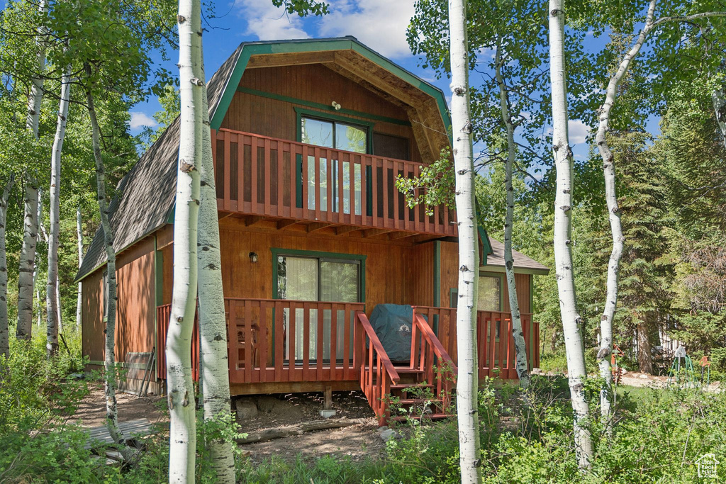 Rear view of house featuring a balcony