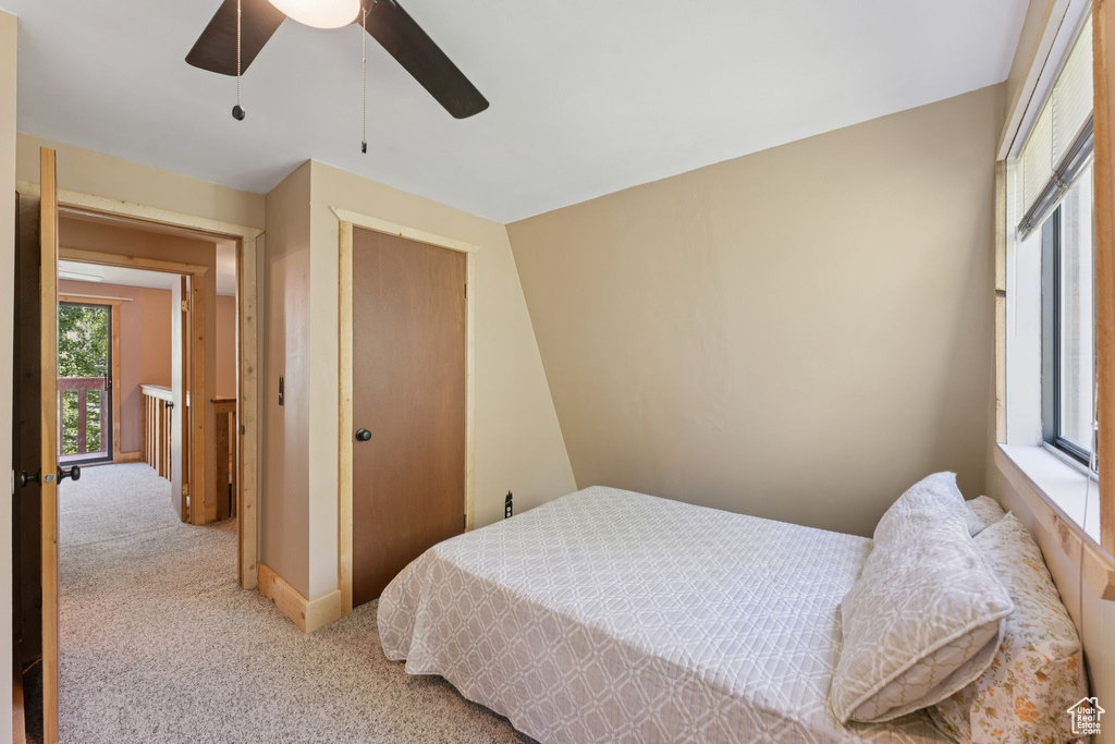 Bedroom featuring light carpet, a closet, and ceiling fan