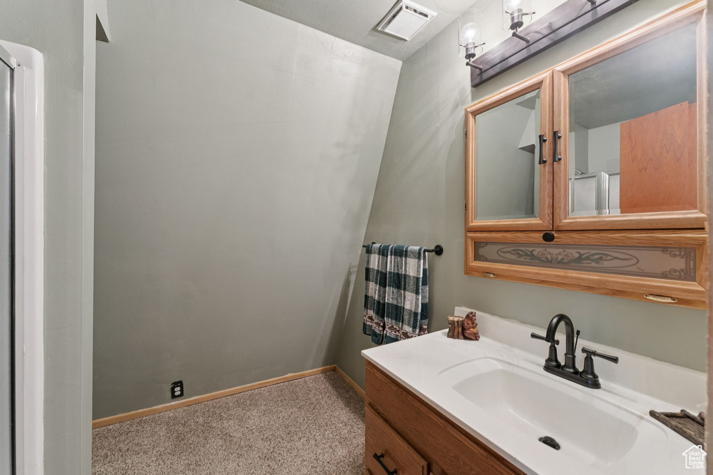 Bathroom featuring vanity and baseboards
