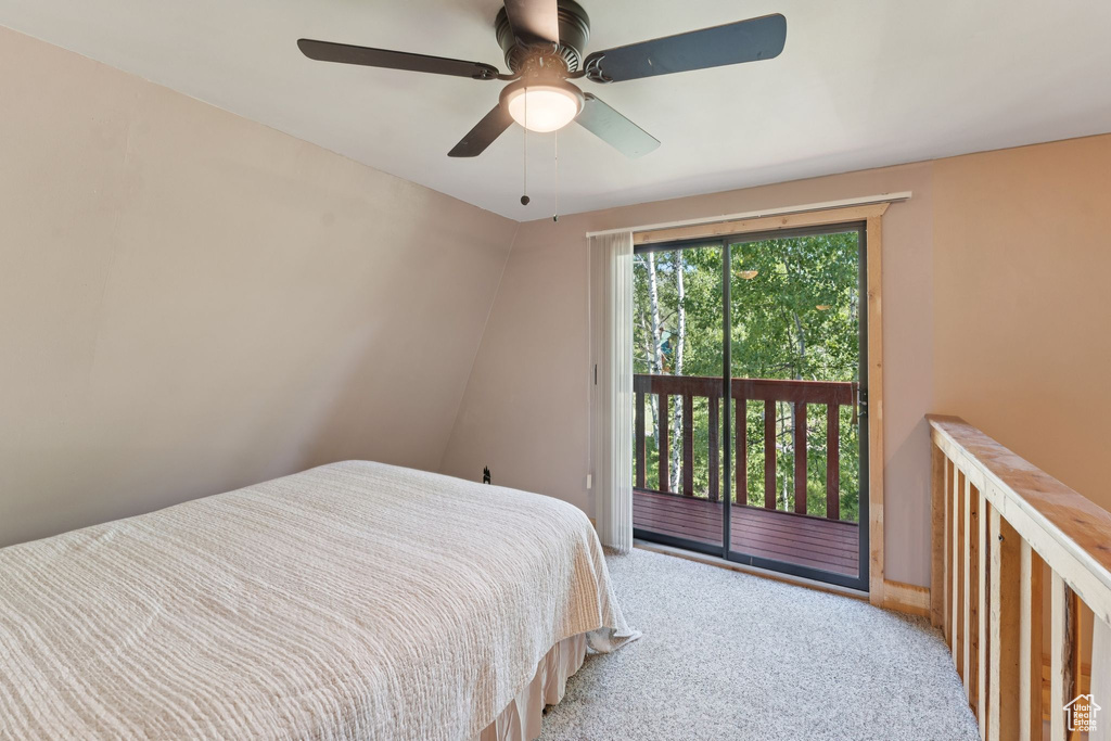 Bedroom with access to exterior, carpet, and a ceiling fan