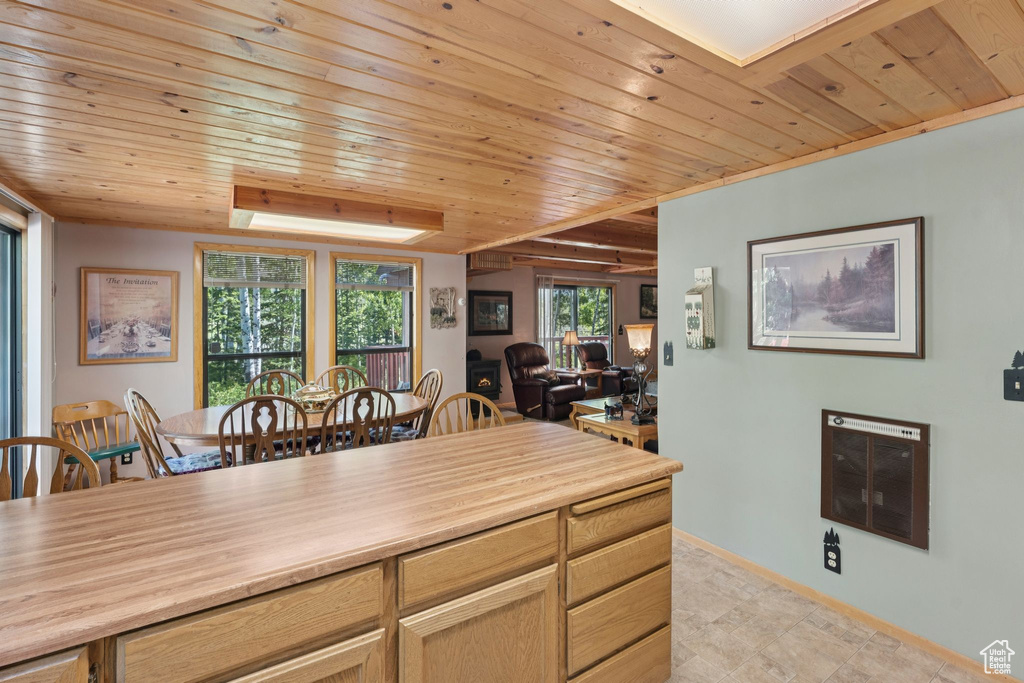 Dining room with heating unit, wood ceiling, and baseboards