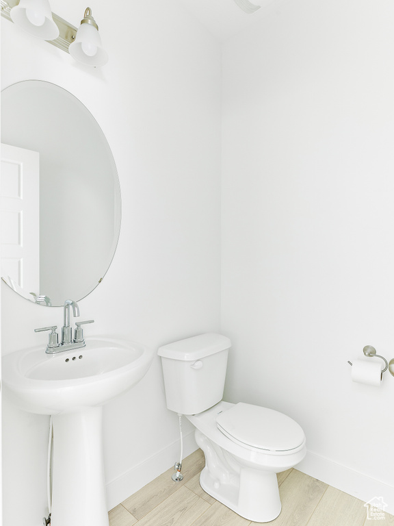 Bathroom featuring toilet and wood finished floors