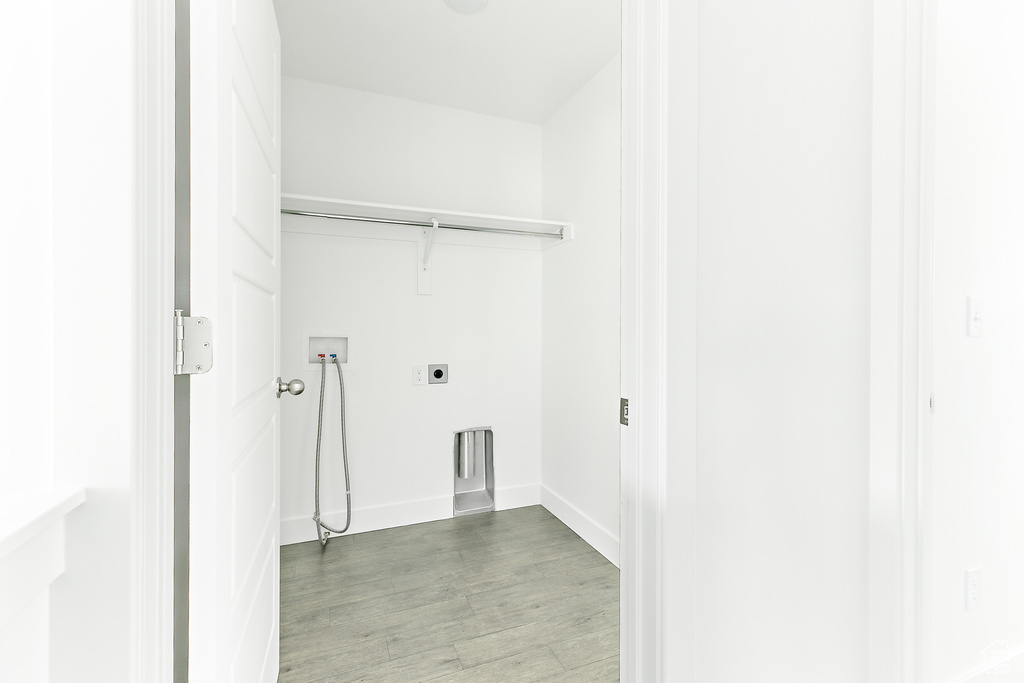 Laundry room featuring washer hookup, wood finished floors, and electric dryer hookup