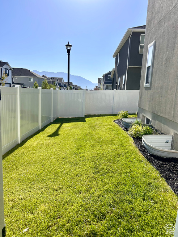 Fenced backyard featuring a mountain view and a residential view