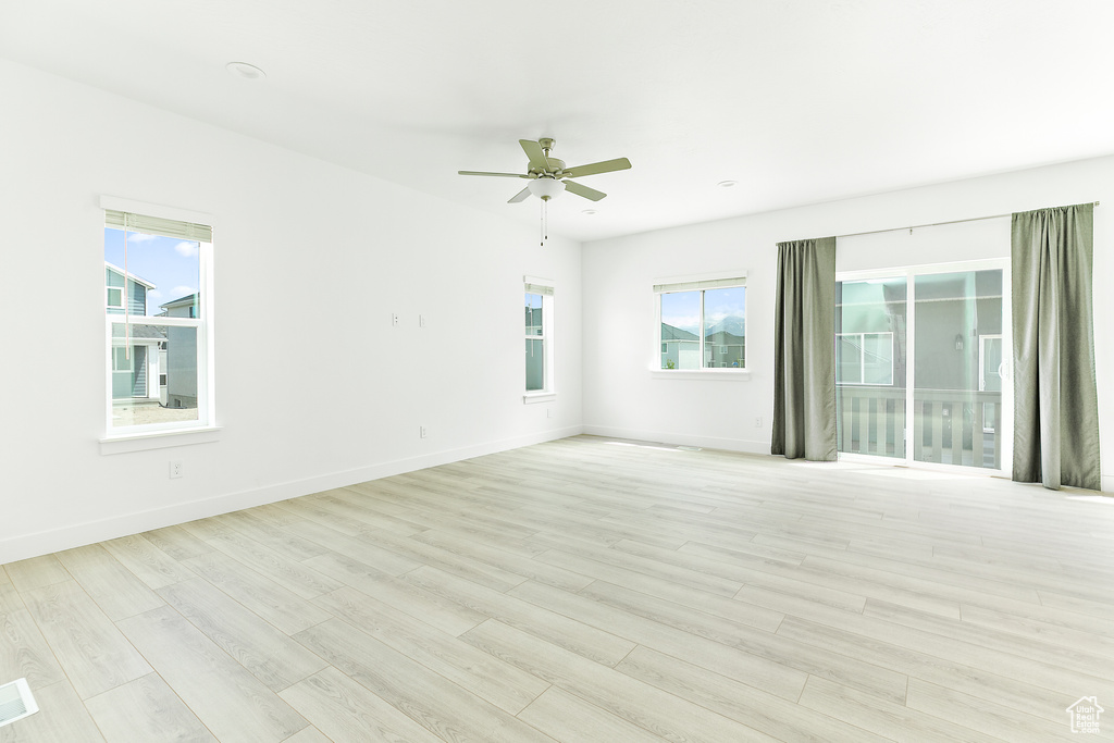 Spare room featuring light wood-type flooring and ceiling fan