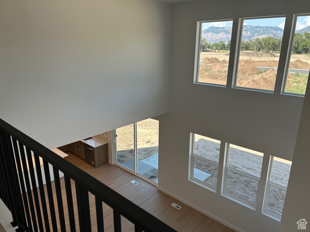 Stairs with wood finished floors and a mountain view