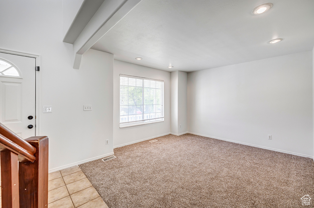 Entryway with recessed lighting, light colored carpet, and light tile patterned floors