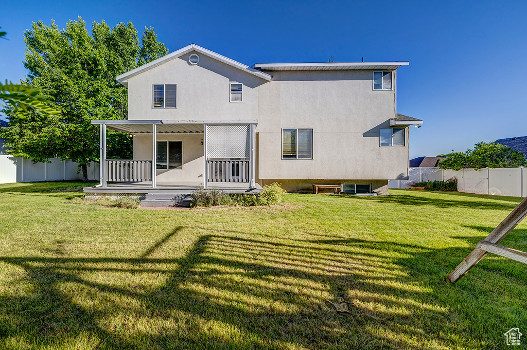 Back of house with a porch and stucco siding