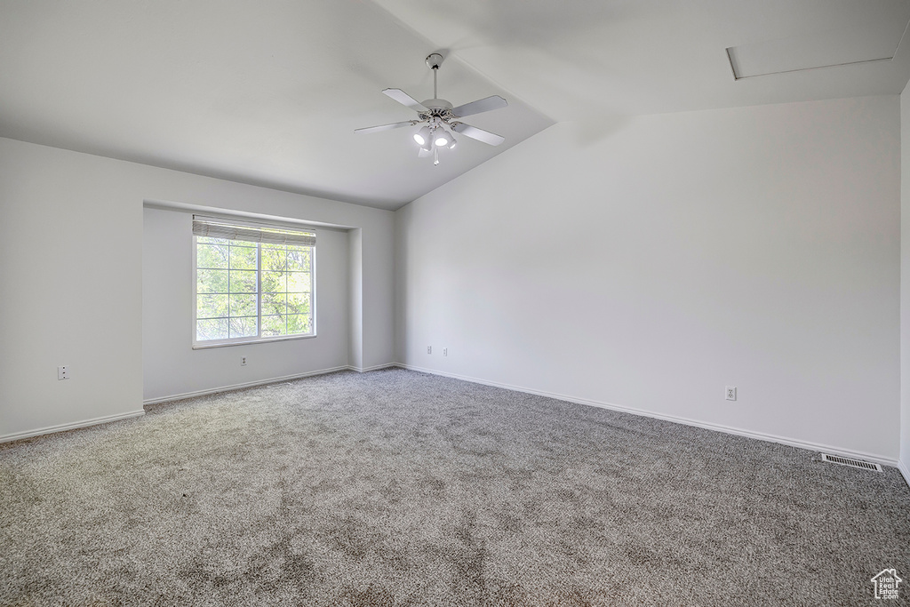 Unfurnished room with carpet flooring, ceiling fan, and lofted ceiling