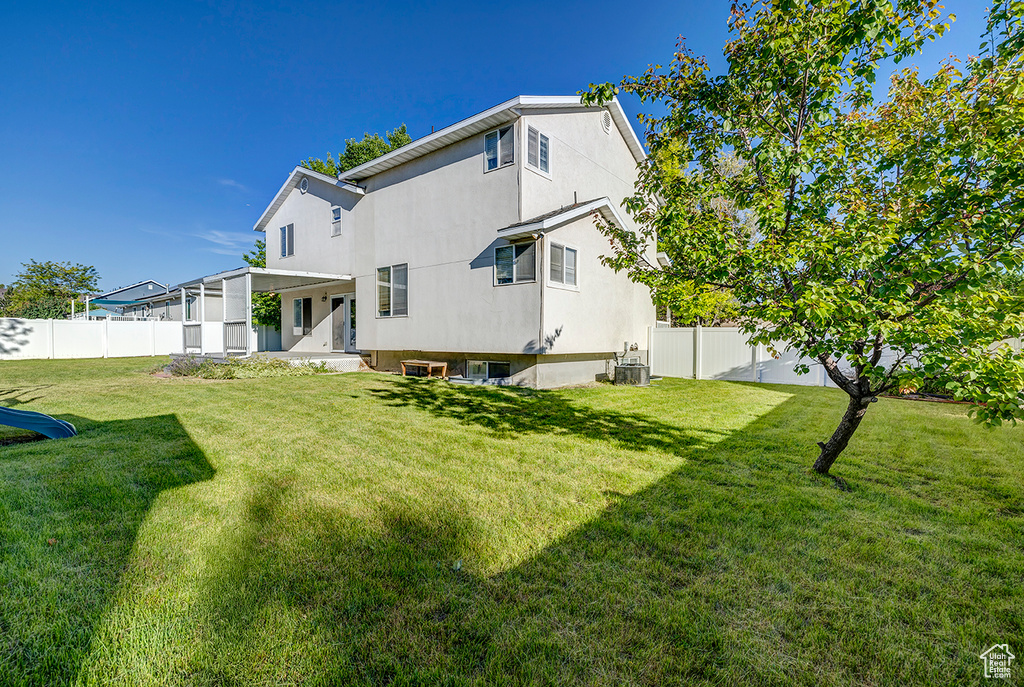 Back of house with a fenced backyard