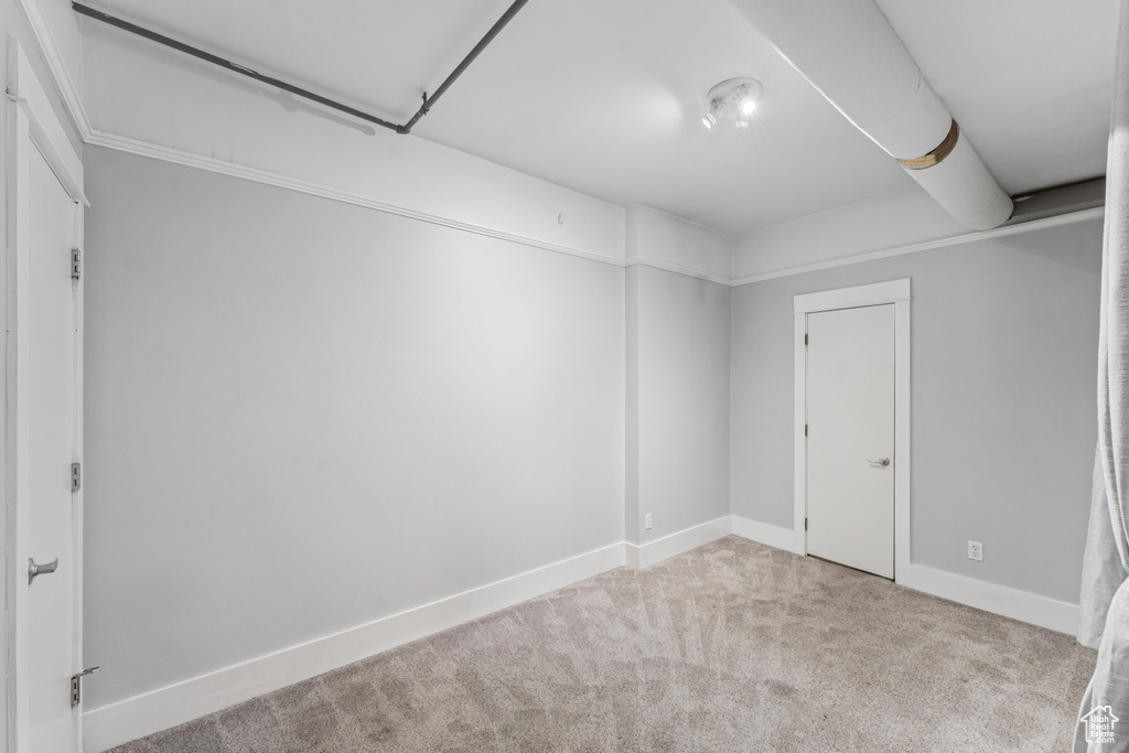 Unfurnished room with carpet and baseboards