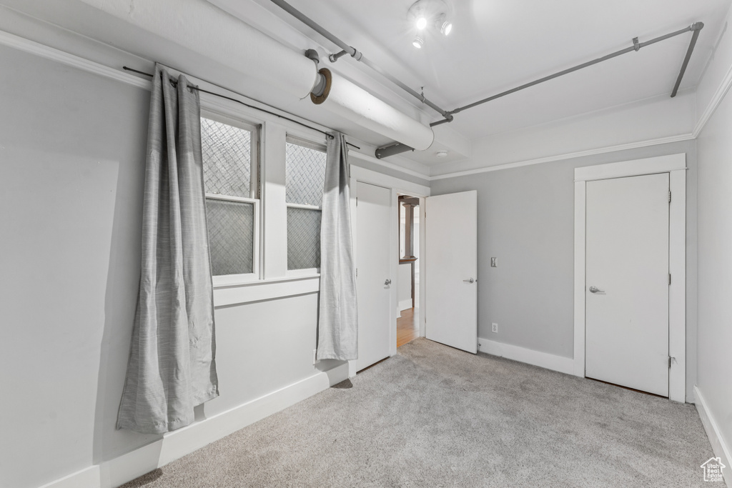 Unfurnished bedroom with carpet and baseboards