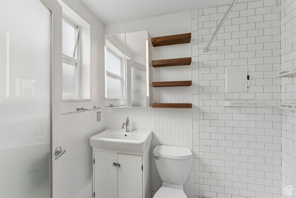 Bathroom featuring vanity and a shower