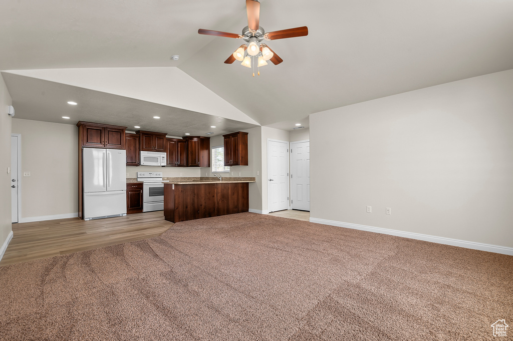 Unfurnished living room featuring recessed lighting, ceiling fan, high vaulted ceiling, and light carpet