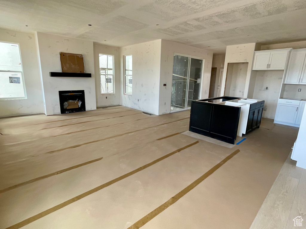 Kitchen featuring white cabinets and a fireplace
