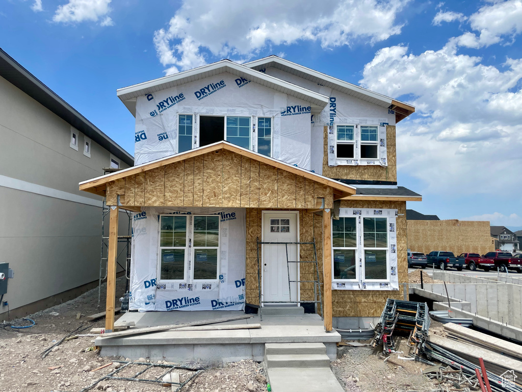 Property in mid-construction featuring a porch