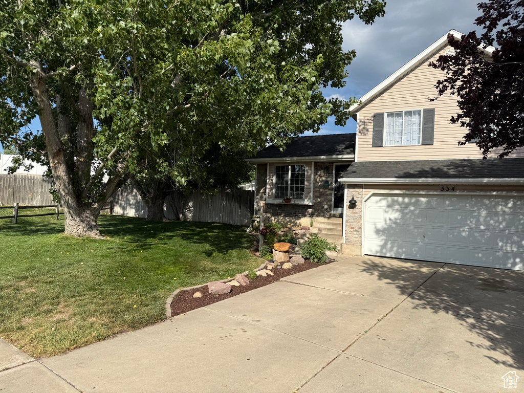 View of front of property featuring driveway and an attached garage