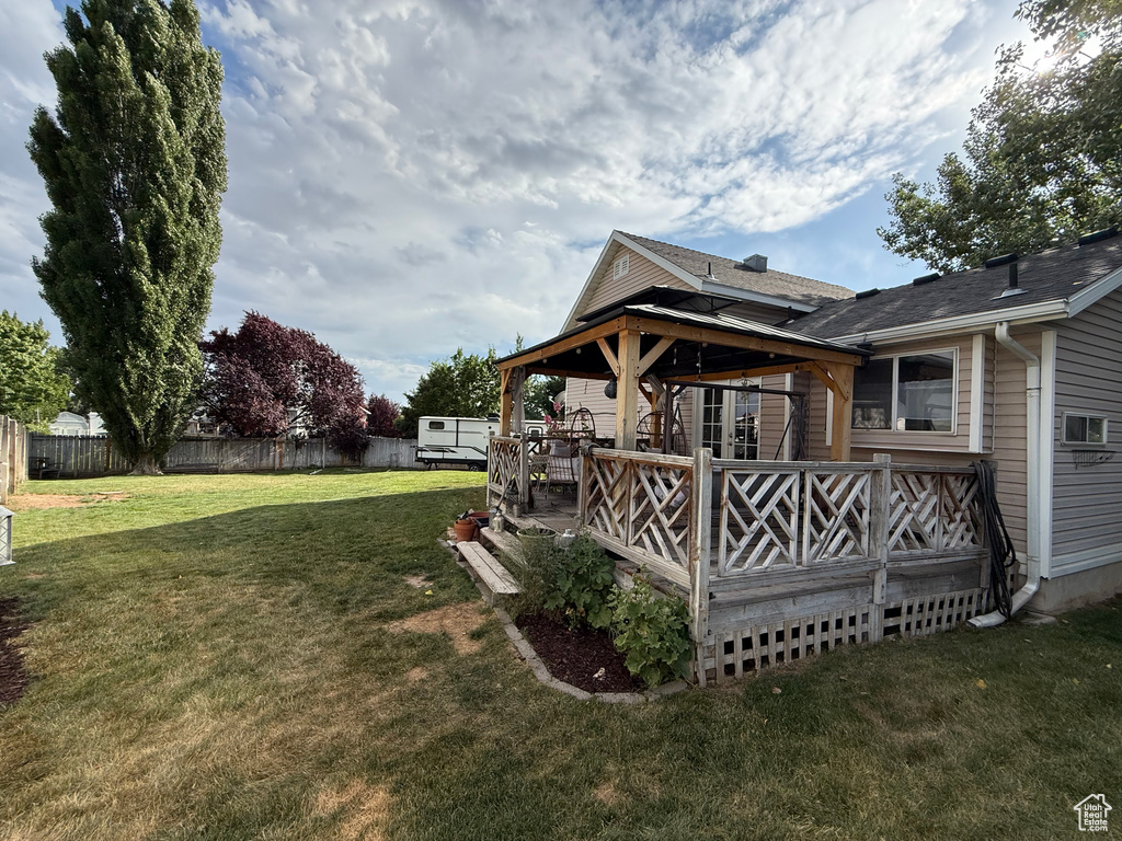 View of yard featuring a deck and a gazebo