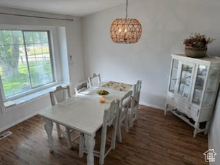 Dining area featuring wood finished floors and a chandelier