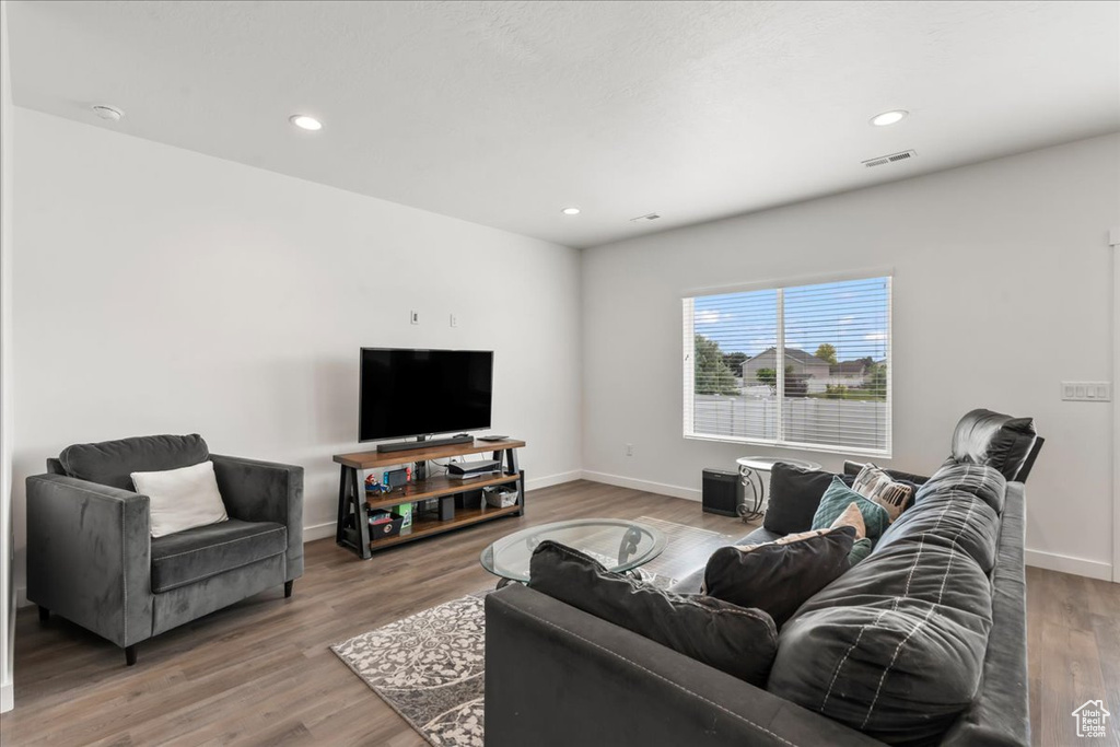 Living area featuring wood finished floors and recessed lighting