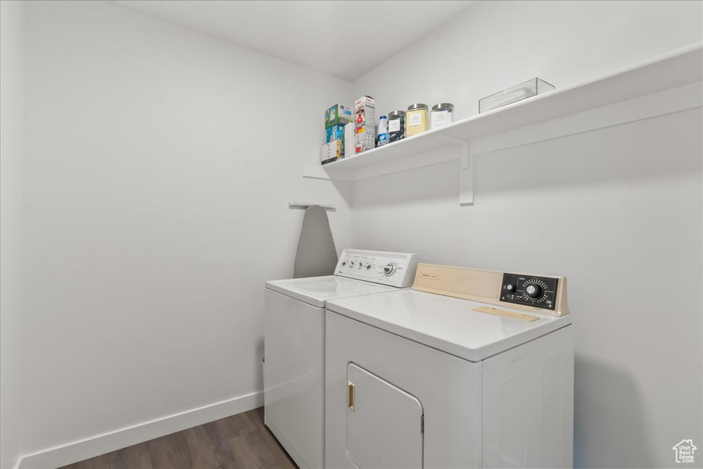 Laundry room featuring independent washer and dryer and dark wood finished floors