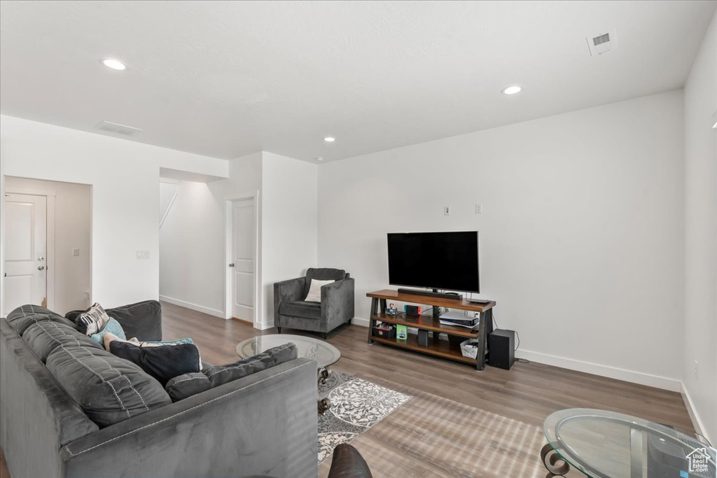 Living area with wood finished floors and recessed lighting