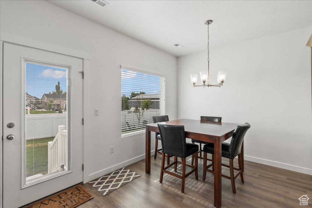 Dining area featuring wood finished floors and a chandelier
