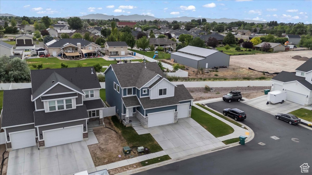 Aerial perspective of suburban area featuring a mountain backdrop