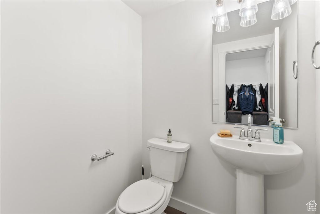 Bathroom featuring toilet and baseboards
