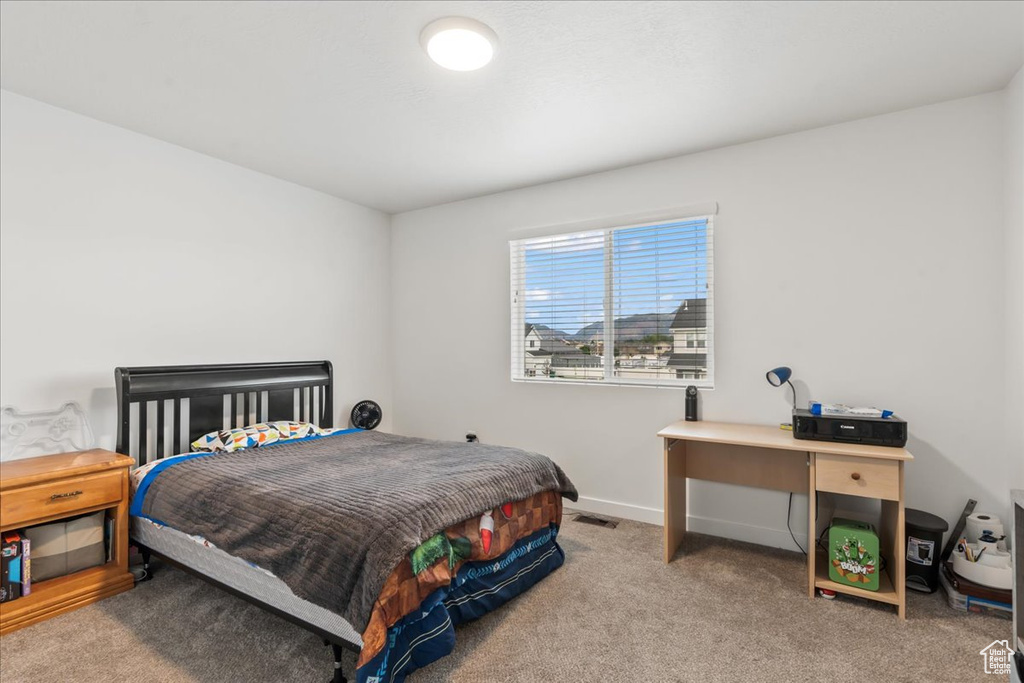 Bedroom featuring carpet floors and baseboards