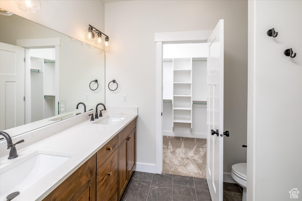 Bathroom with double vanity and toilet